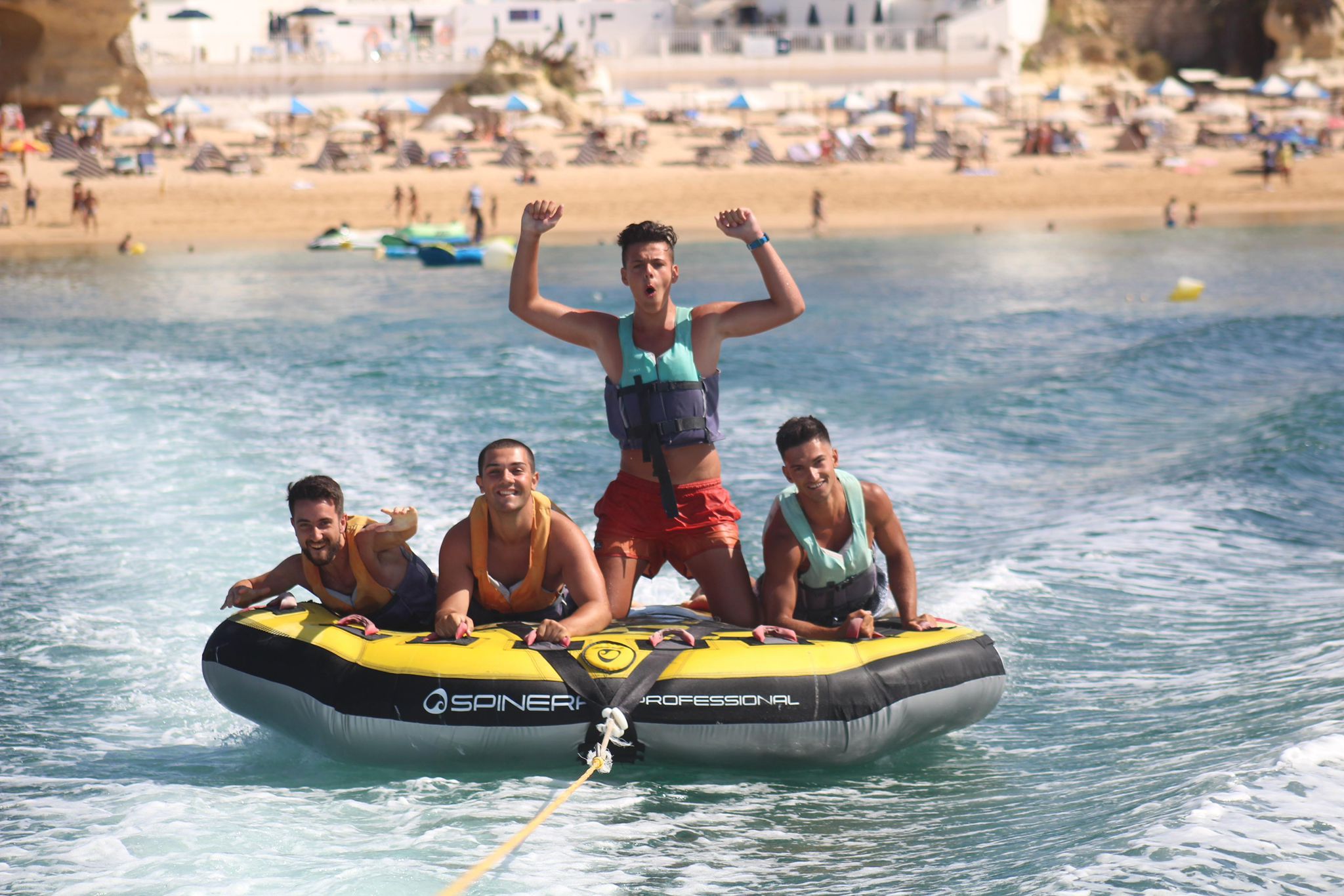 Group riding an inflatable water sports tube