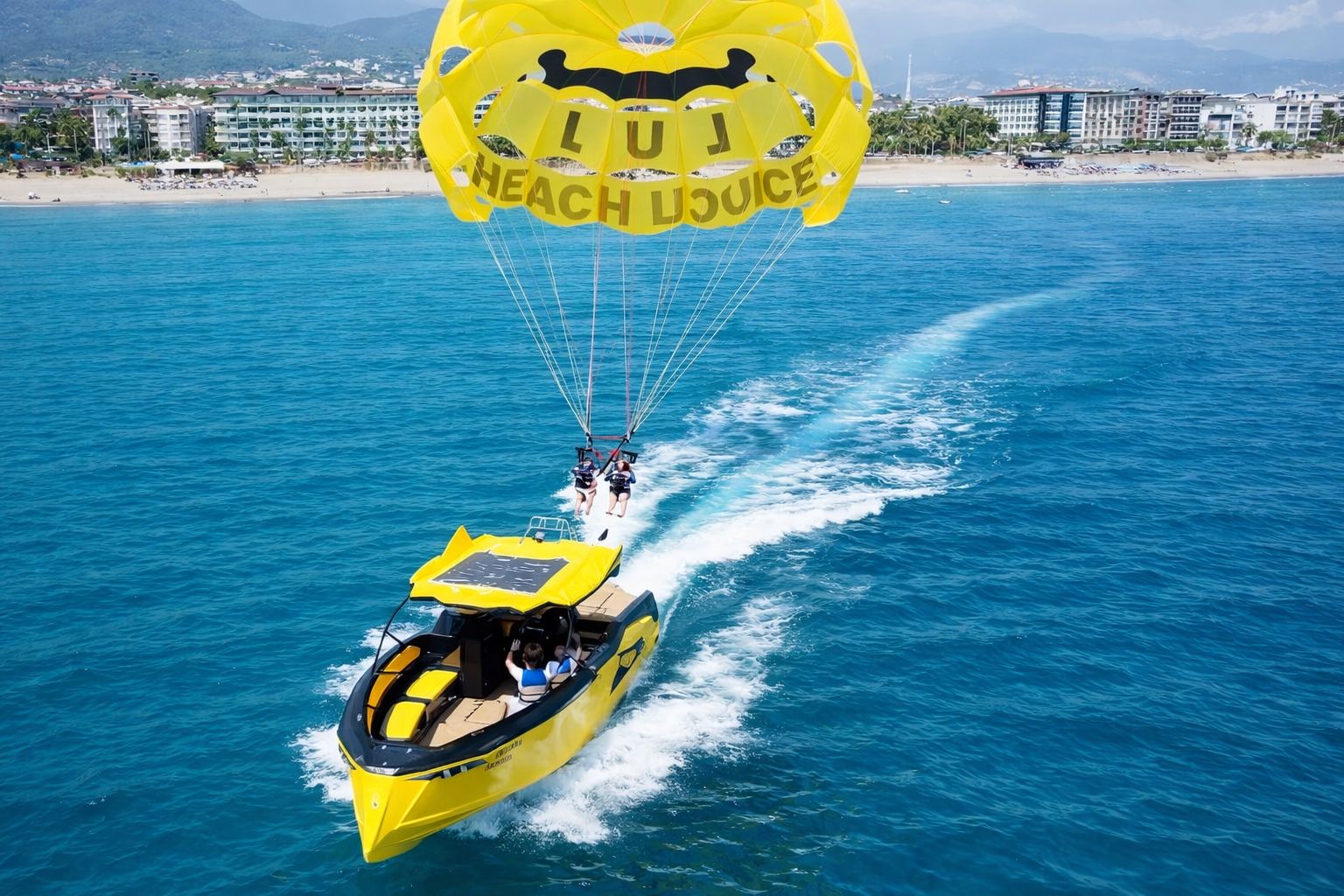Parasailing boat pulling guests over Alanya sea